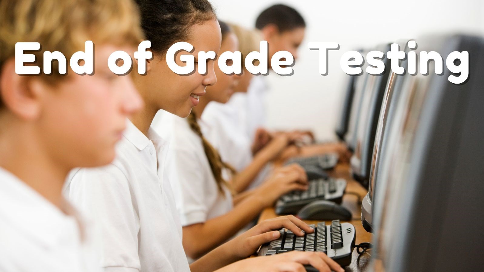 Students in white polos using computers. Text reads: End of Grade Testing